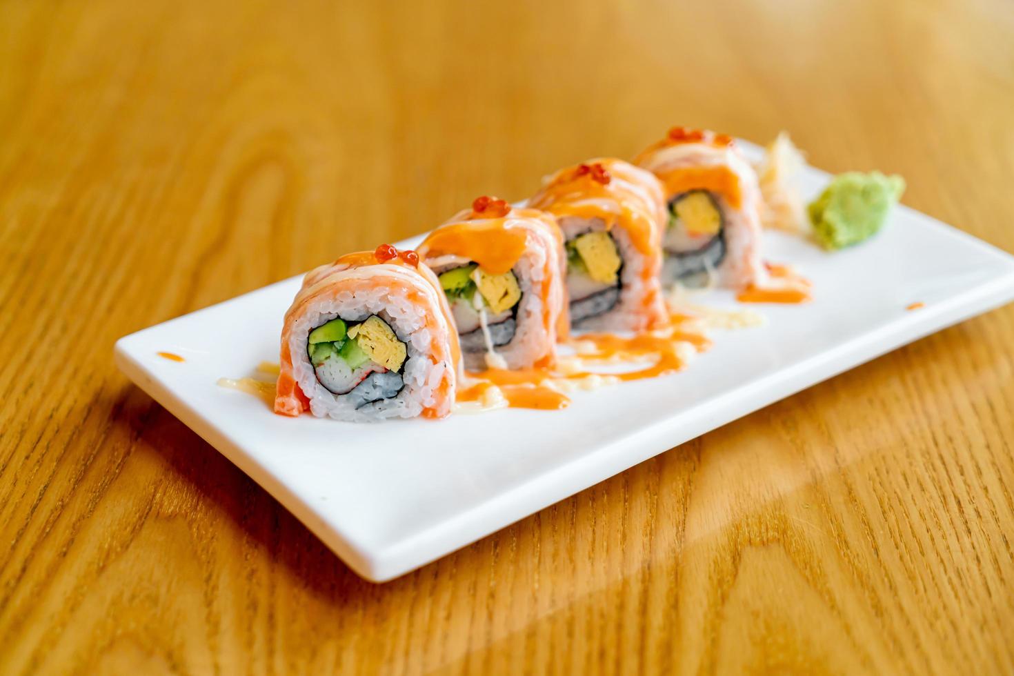 Salmon roll sushi with sauce on top - Japanese food style photo