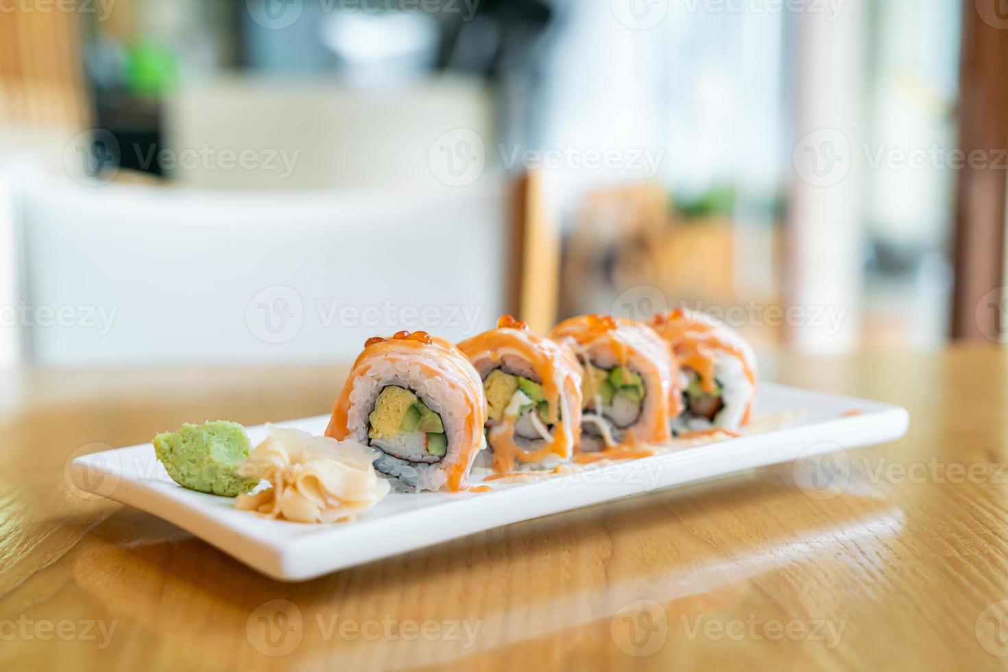 Salmon roll sushi with sauce on top - Japanese food style photo