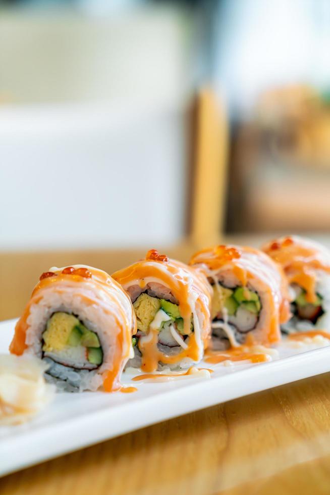 Salmon roll sushi with sauce on top - Japanese food style photo