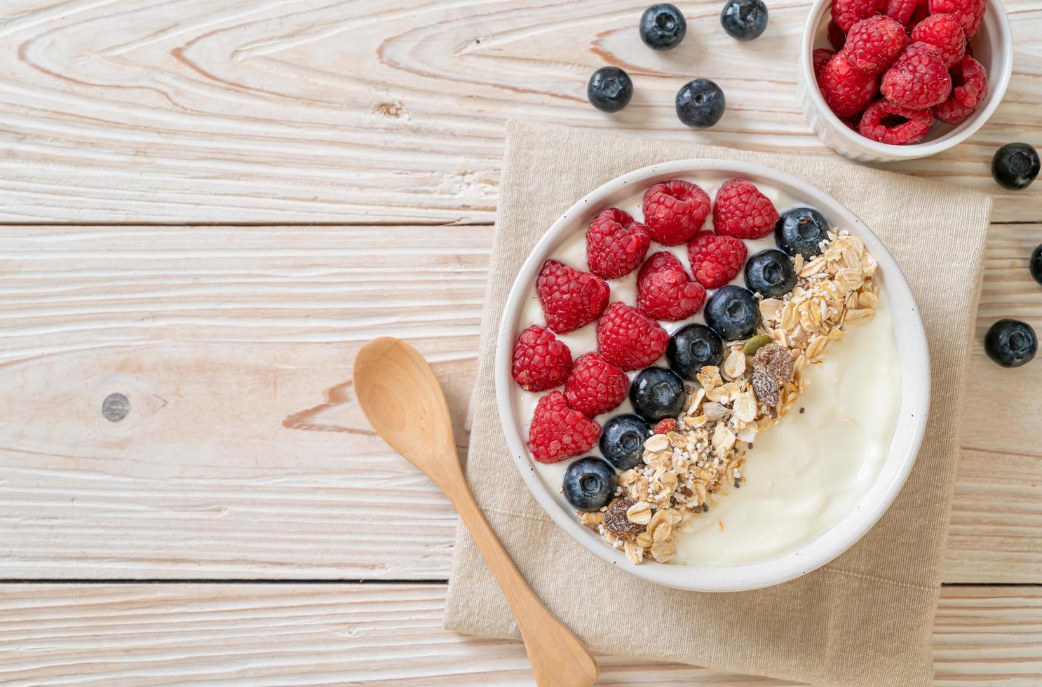 Homemade yogurt bowl with raspberry, blueberry and granola  - healthy food style photo