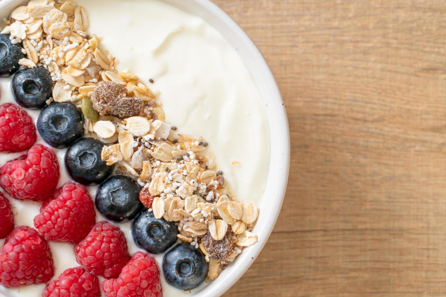 Homemade yogurt bowl with raspberry, blueberry and granola  - healthy food style photo