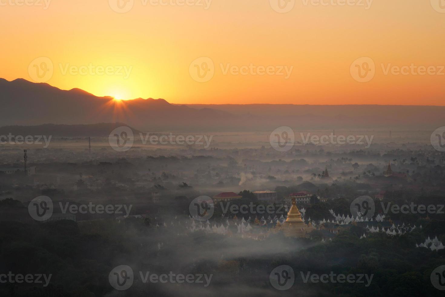 Top view of Mandalay city from Mandalay hill at the sunrise time that the sky turned orange photo