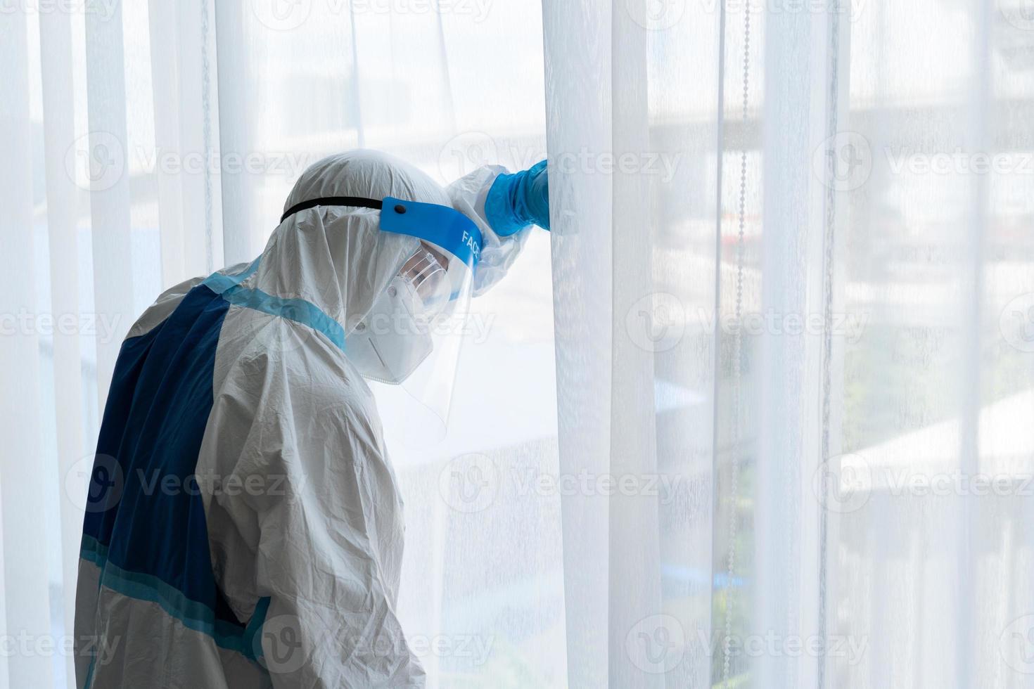 Doctor in personal protective equipment or ppe feeling sad after patient with covid-19 or coronavirus infection has died in the isolation unit during pandemic. medical concept photo