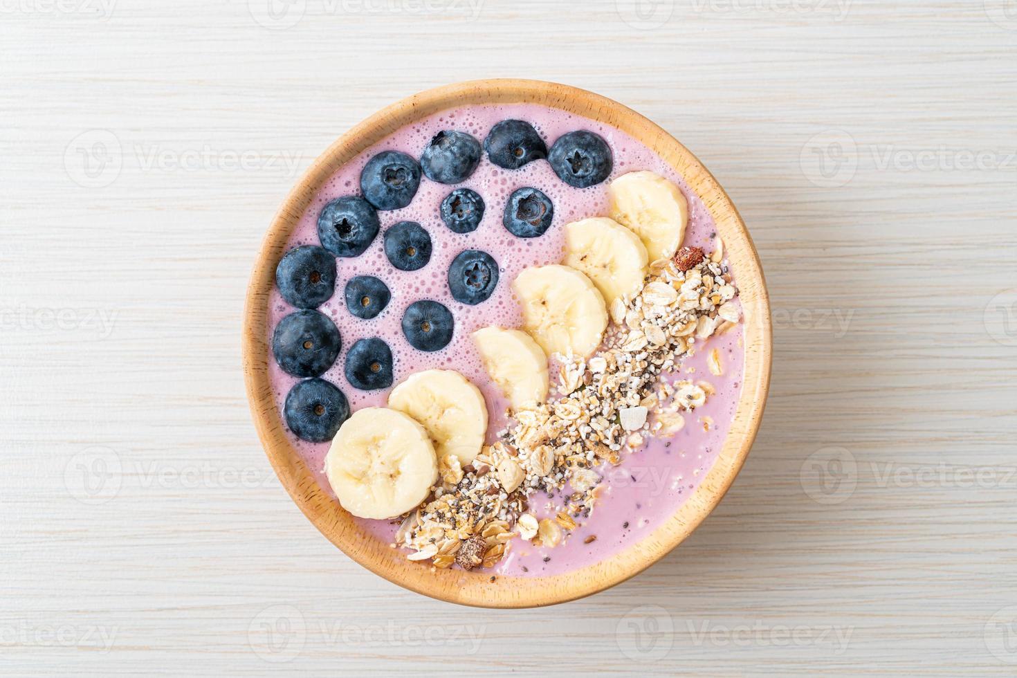 Yogurt or smoothie bowl with blueberry, banana, and granola - Healthy food style photo