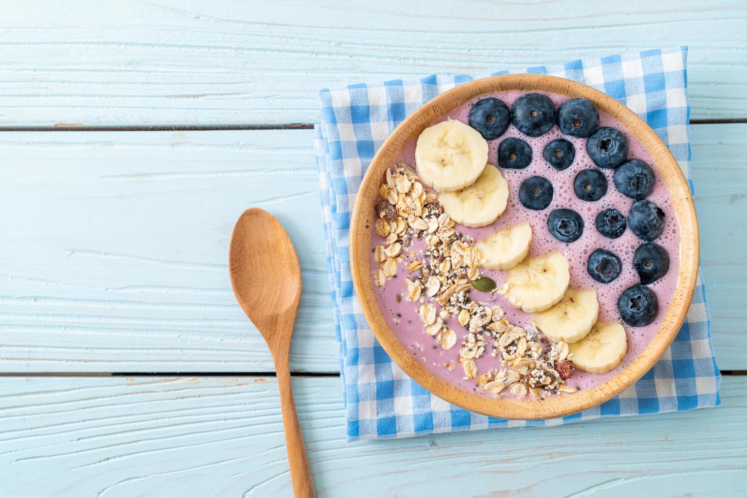 Yogurt or smoothie bowl with blueberry, banana, and granola - Healthy food style photo
