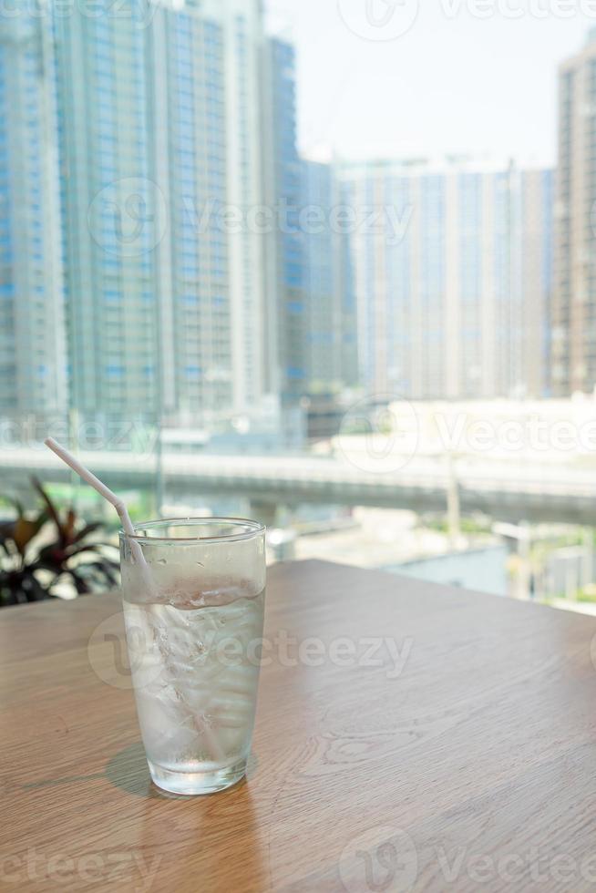 Water glass with ice on table photo