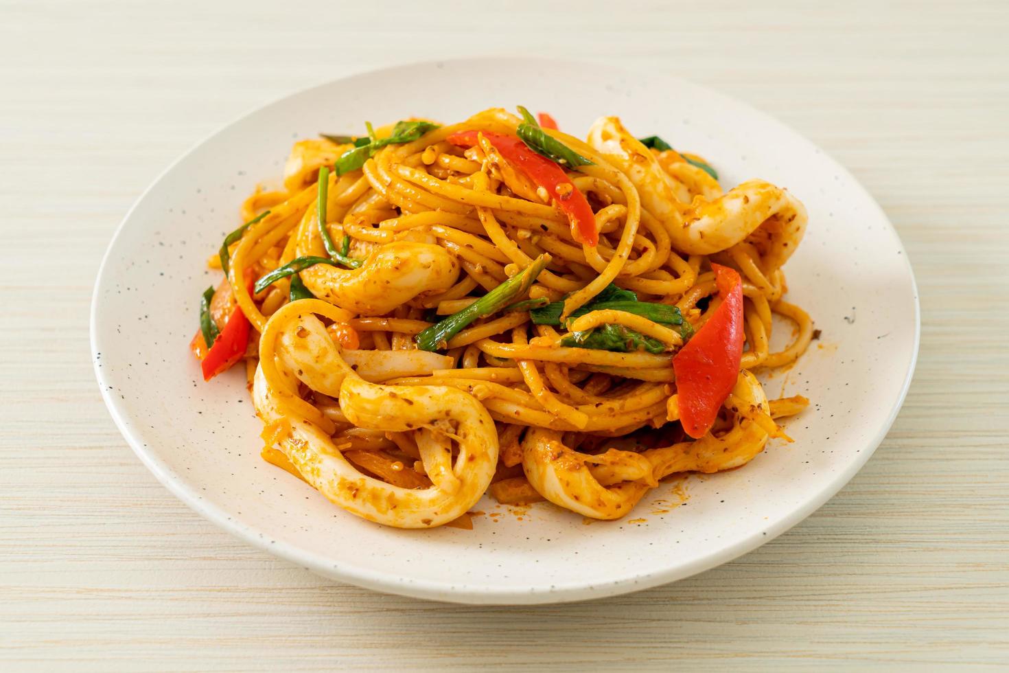 Stir-fried spaghetti with salted egg and squid - fusion food style photo