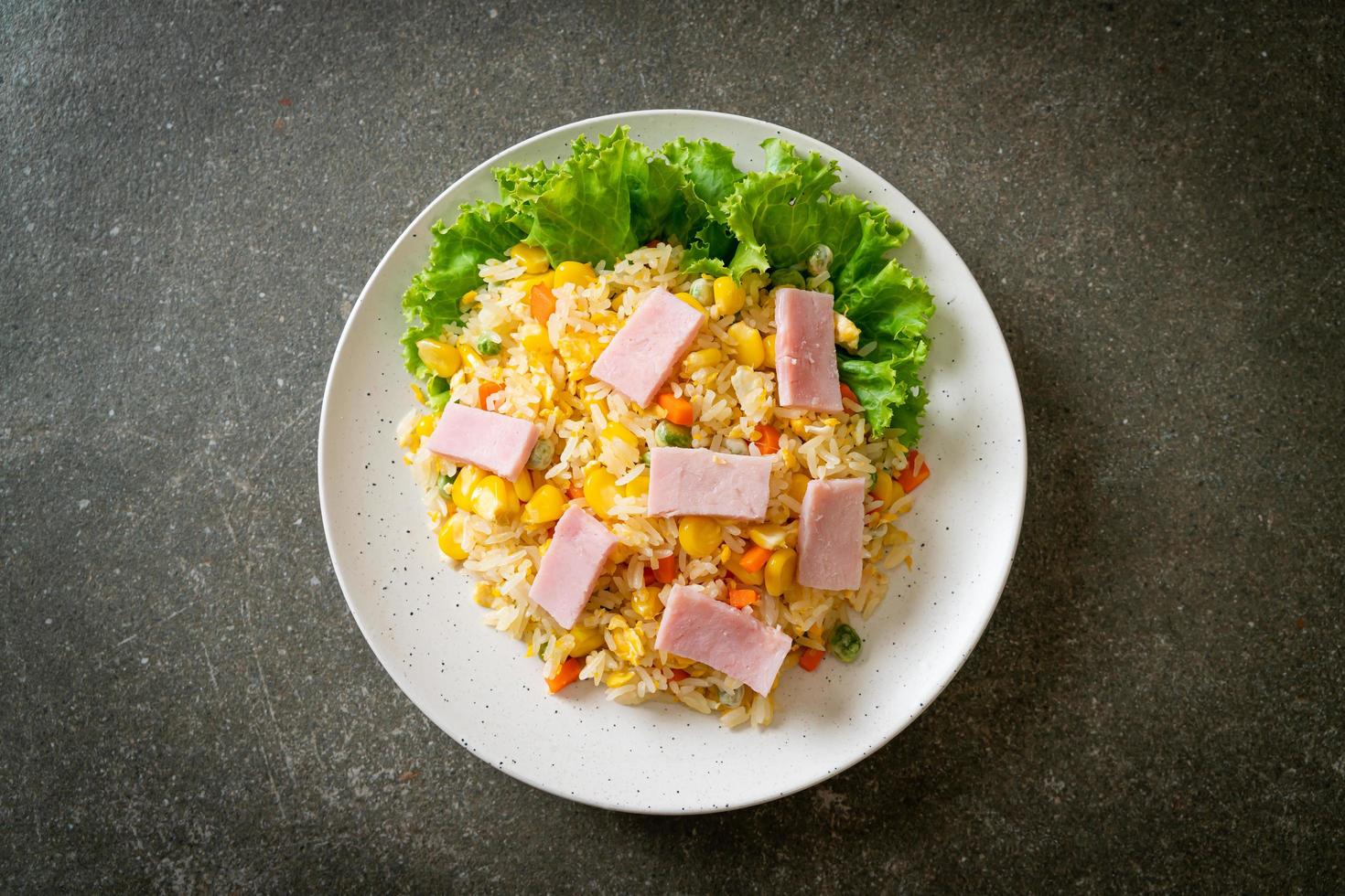 Homemade fried rice with ham and mixed vegetables of carrot and green bean peas photo