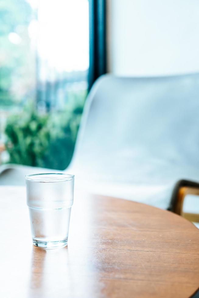 Glass of water on wood table photo