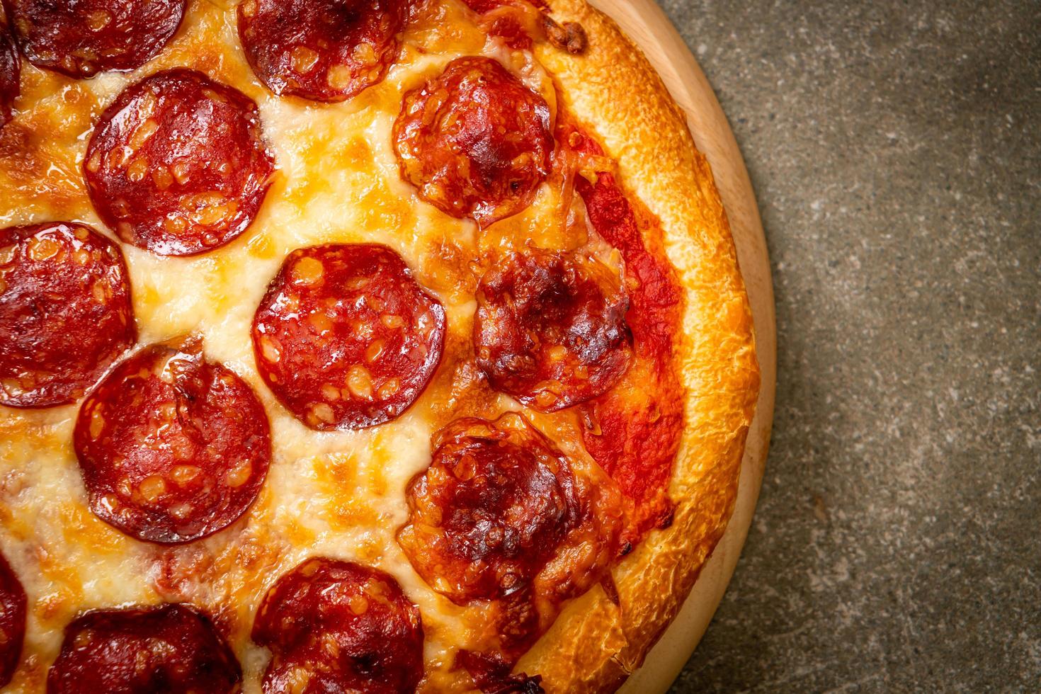 Pepperoni pizza on wood tray - Italian food style photo