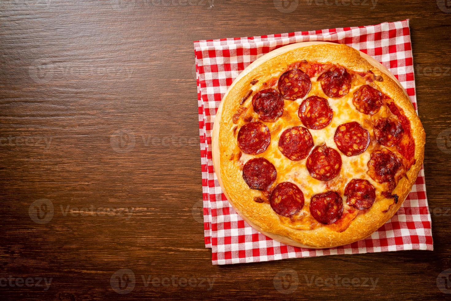 Pepperoni pizza on wood tray - Italian food style photo