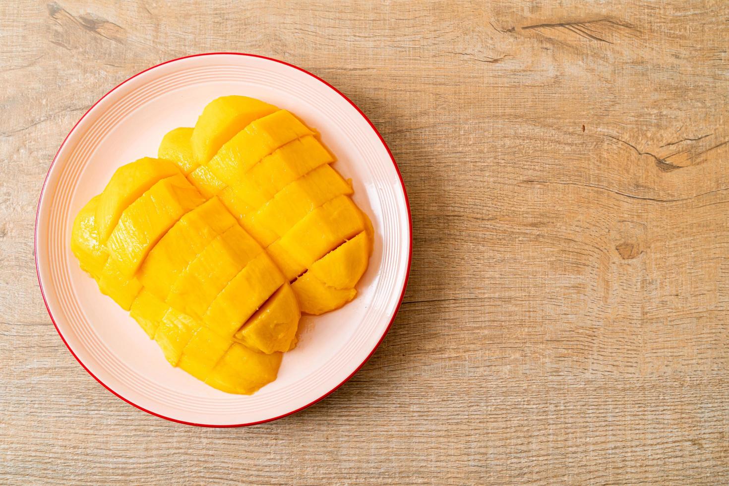 Fresh and golden mango sliced on plate photo