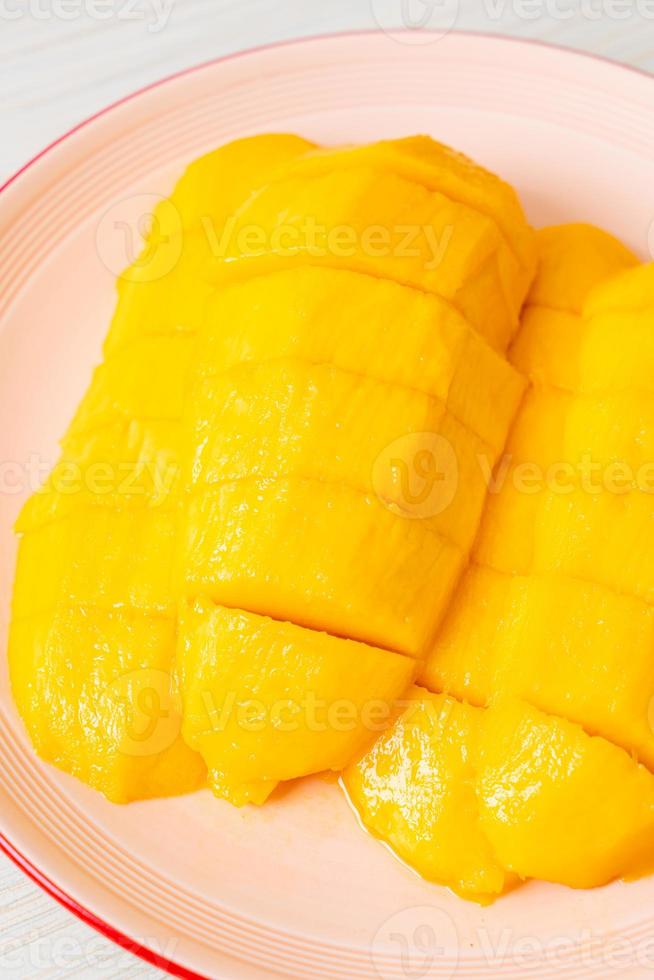 Fresh and golden mango sliced on plate photo