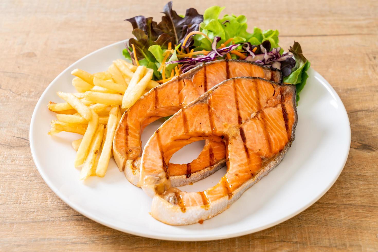 Double grilled salmon steak fillet with french fries photo