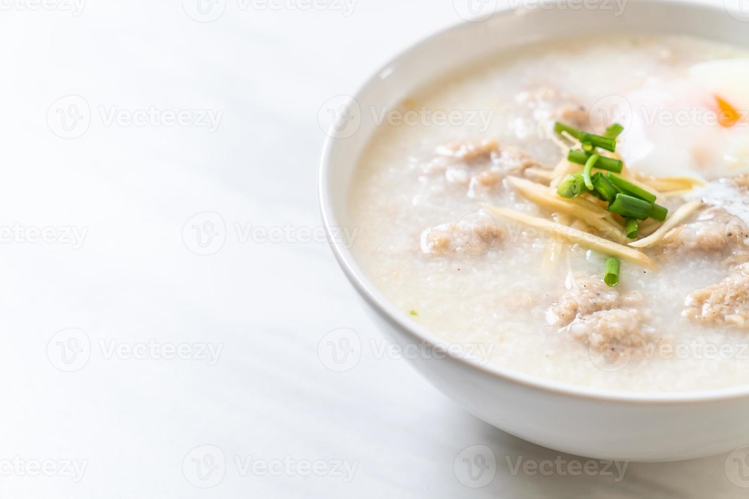 Congee con carne de cerdo picada en un tazón - estilo de desayuno asiático foto