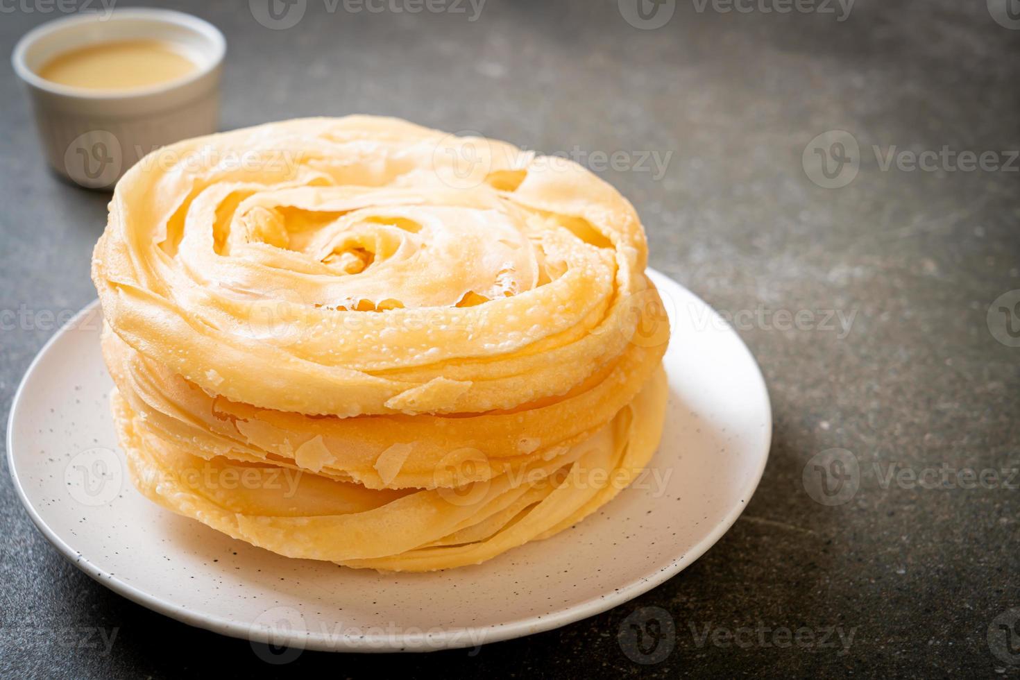 Friied crispy roti dough with sweetened condensed milk photo