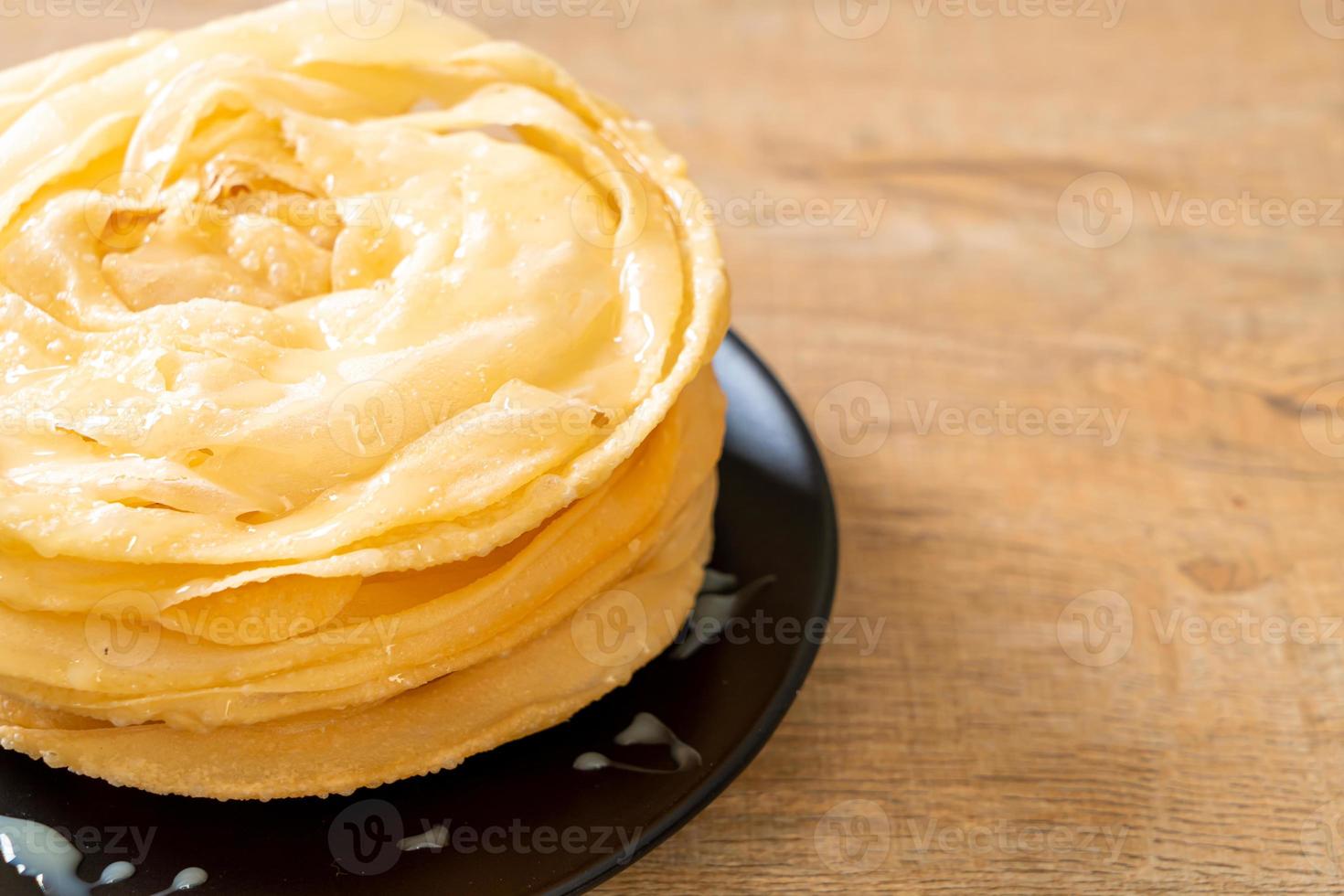 Friied crispy roti dough with sweetened condensed milk photo