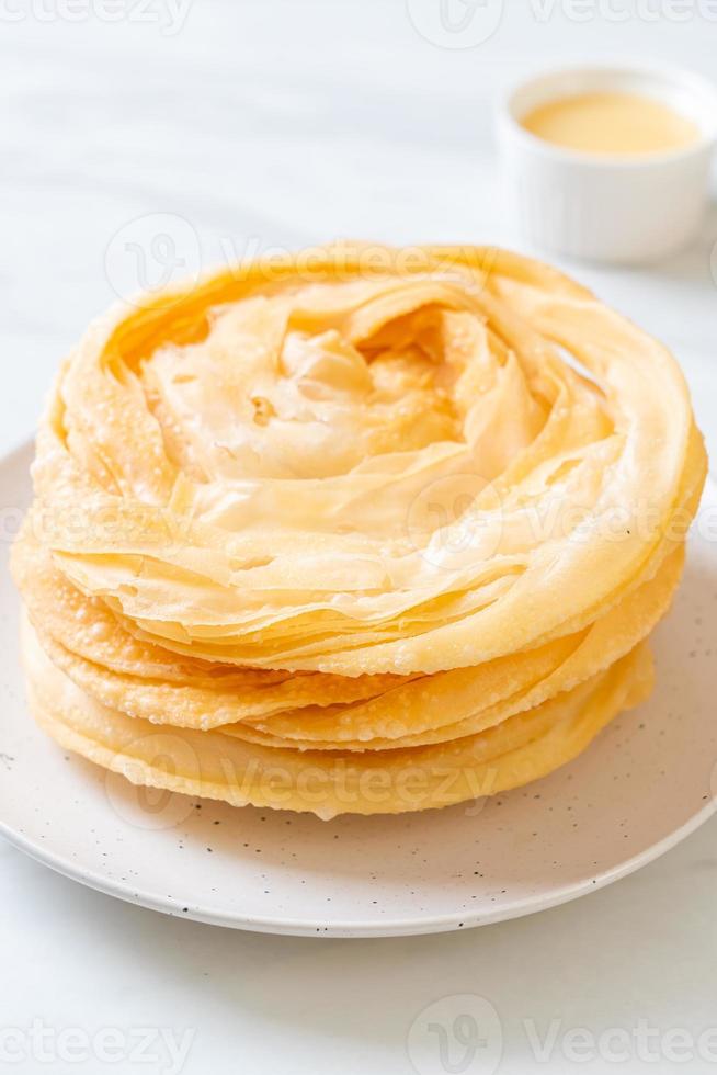 Friied crispy roti dough with sweetened condensed milk photo