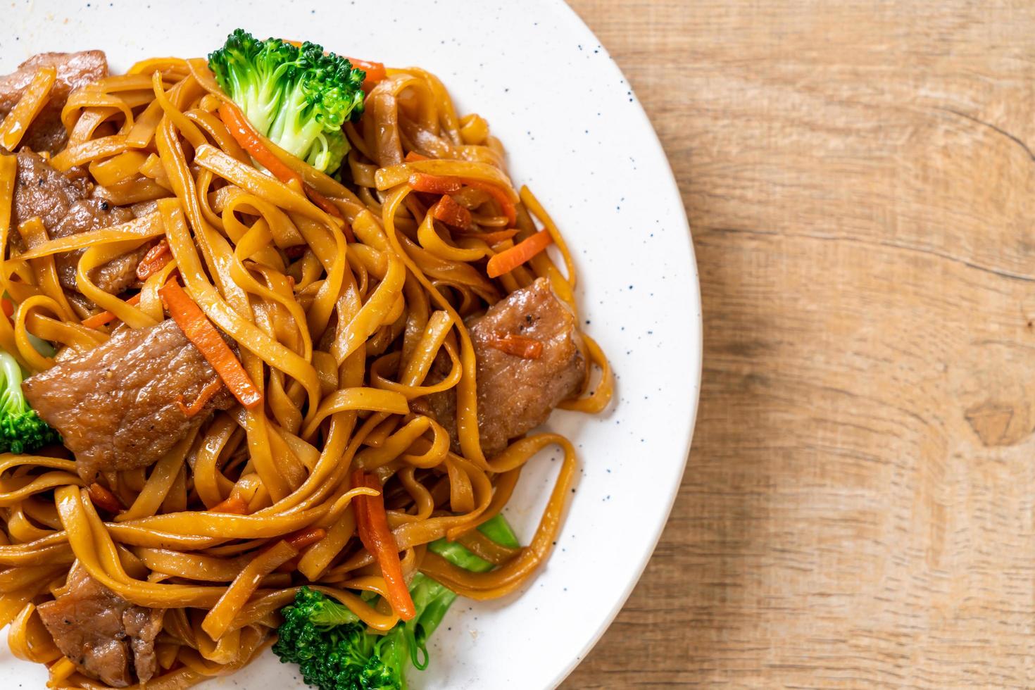 Stir-fried noodles with pork and vegetable - Asian food style photo