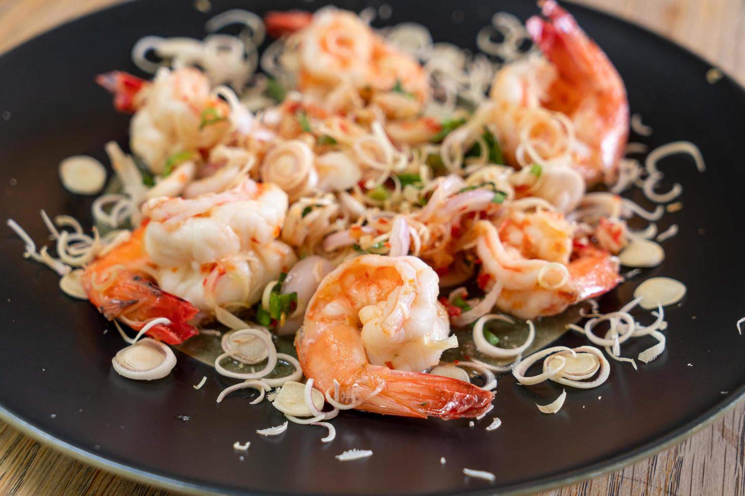 Spicy shrimp salad with herb on plate photo