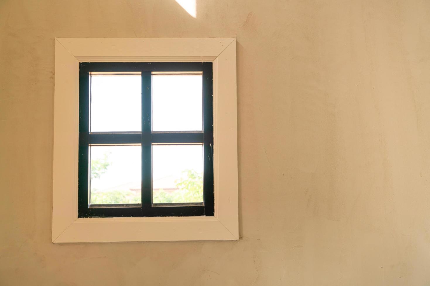 Window on wall with sunlight and copy space photo