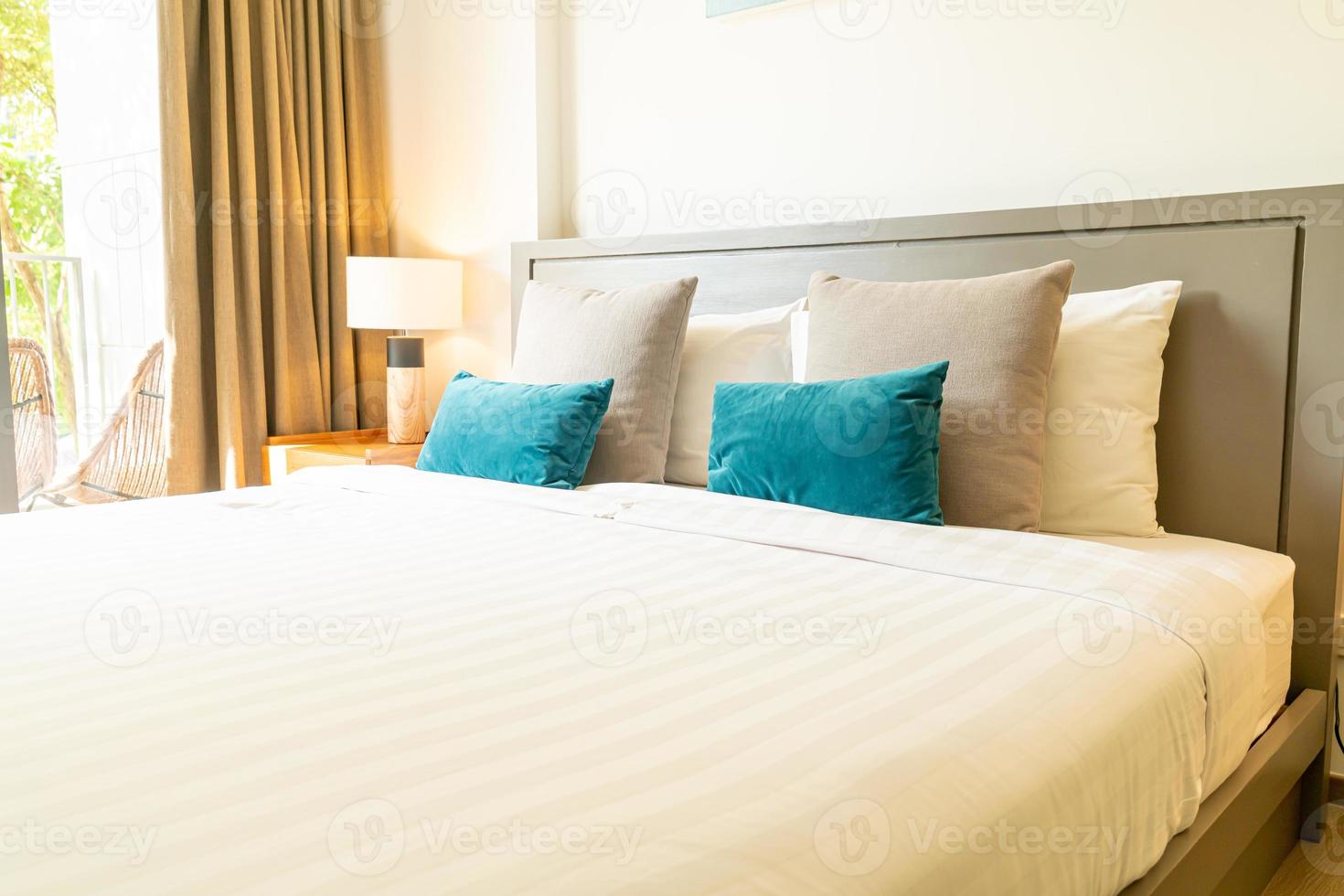 Comfortable pillow decoration on bed in bedroom photo