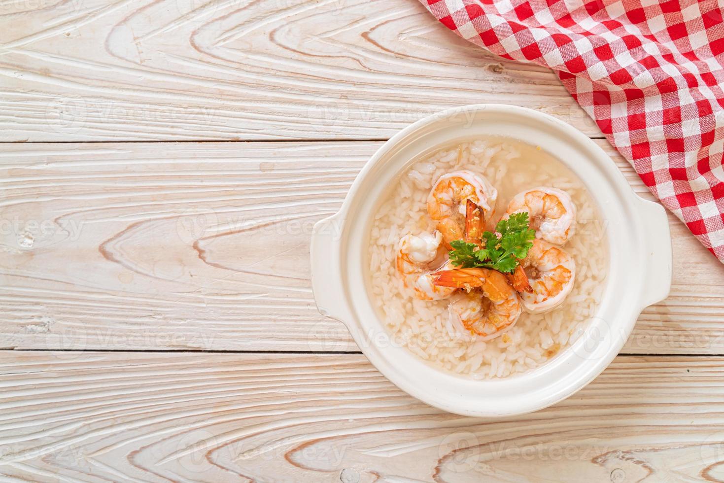 Porridge or boiled rice soup with shrimp bowl photo