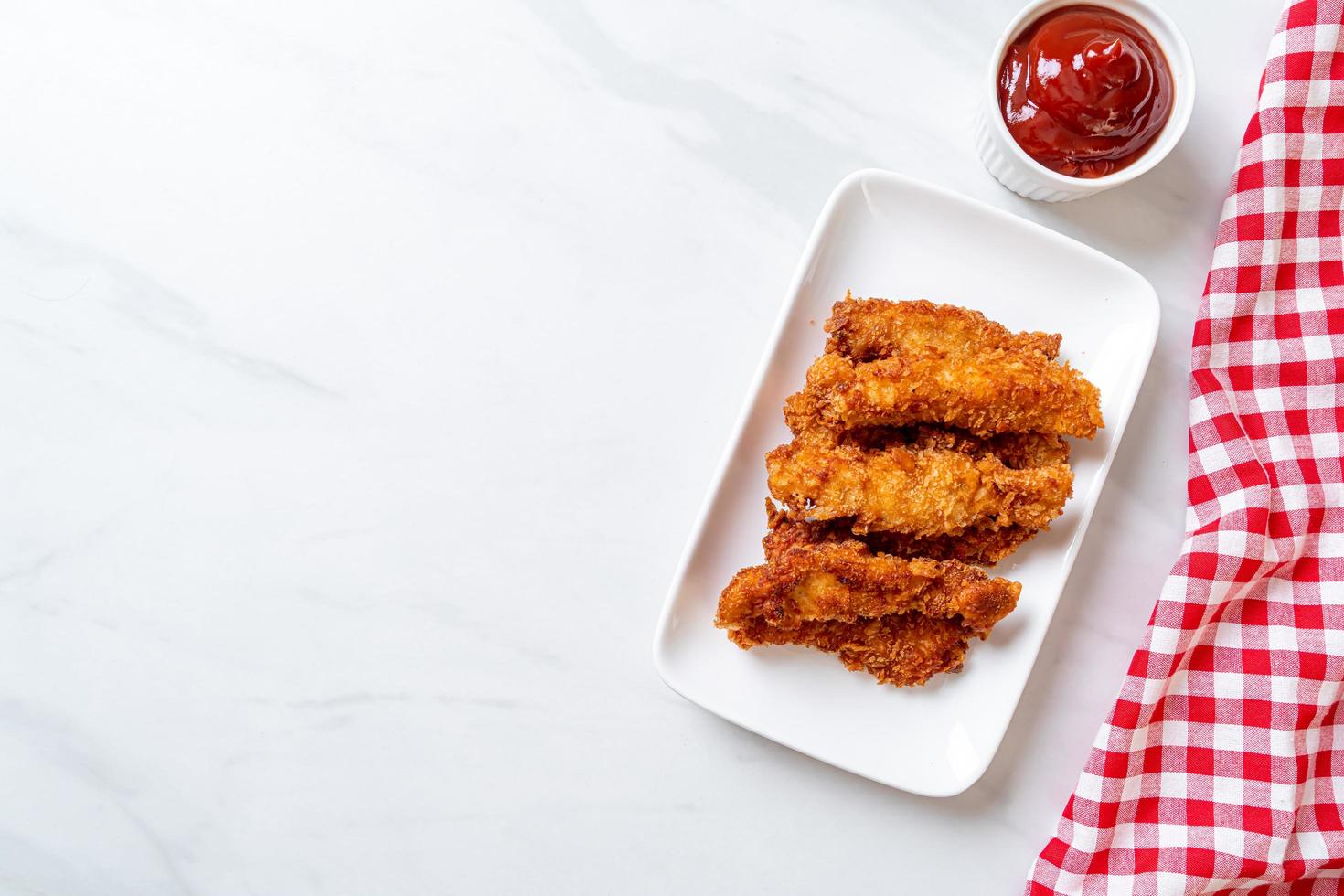 Fried chicken stick with ketchup photo