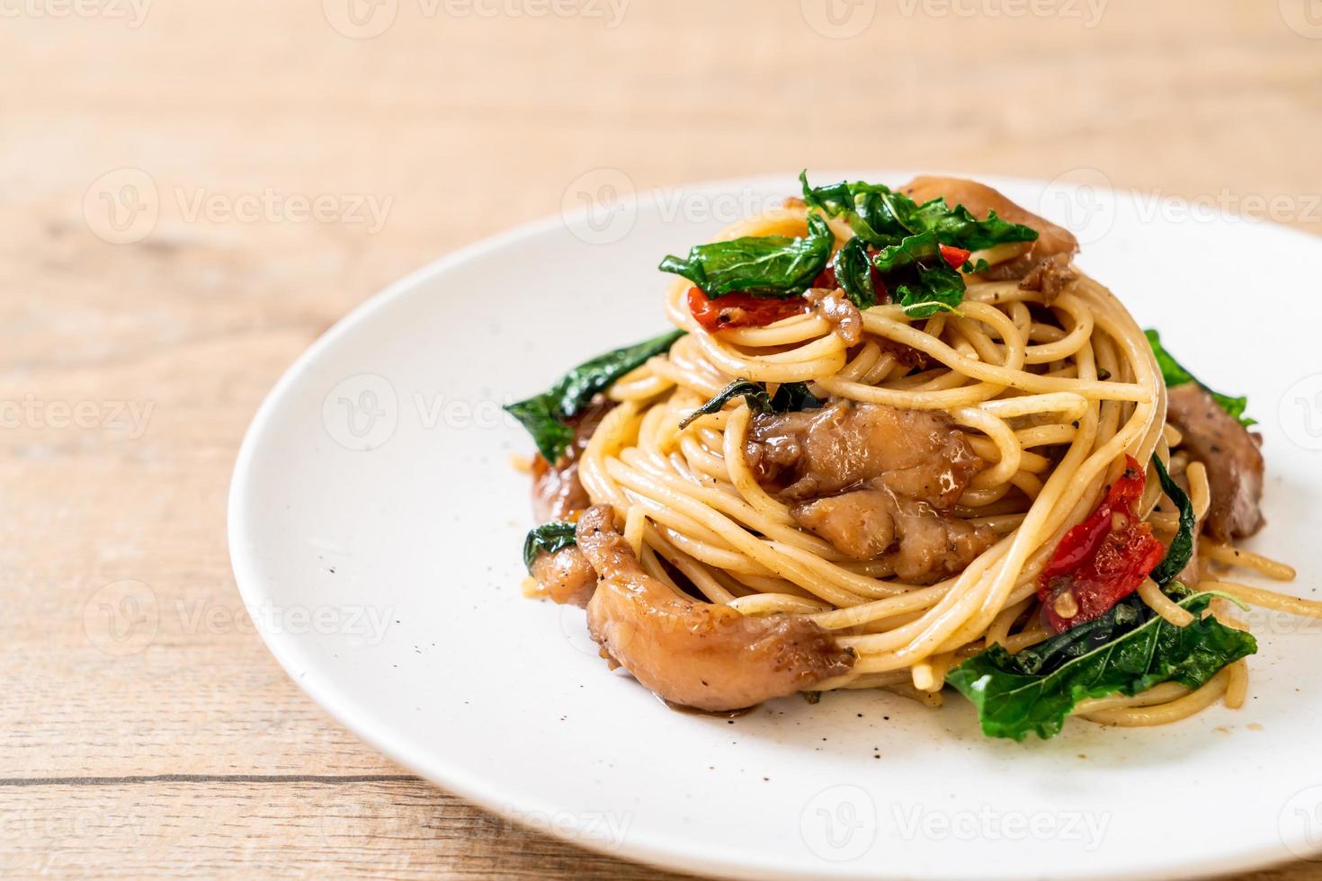 Stir-fried spaghetti with chicken and basil - fusion food style photo