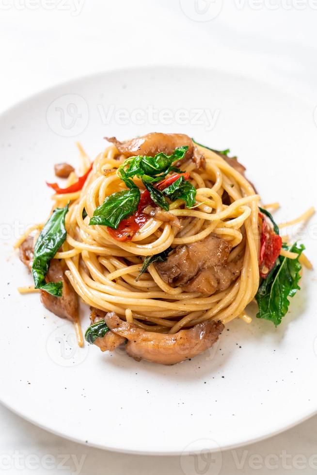 Stir-fried spaghetti with chicken and basil - fusion food style photo