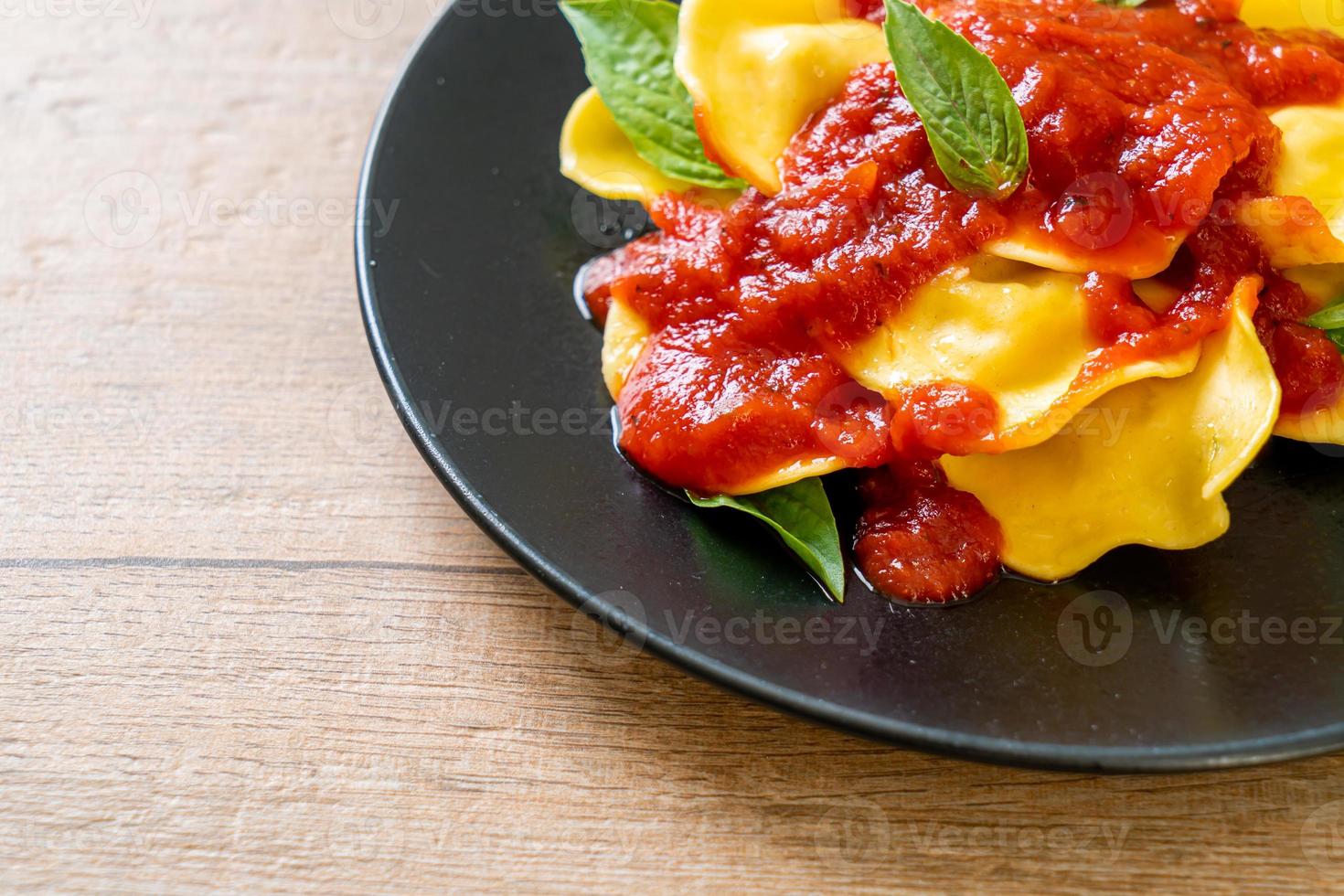 Ravioli with tomato sauce and basil photo