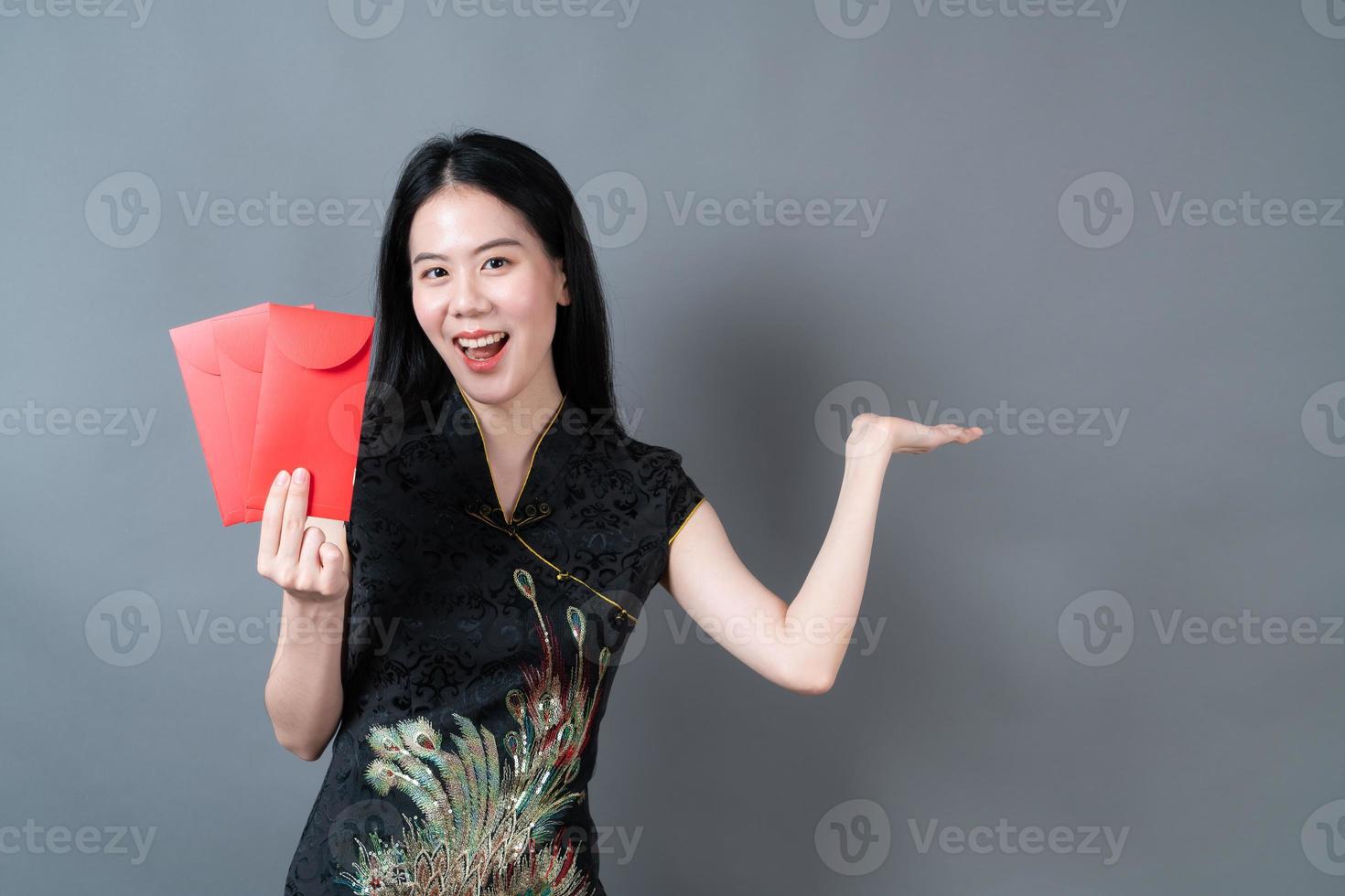 Asian woman wear Chinese traditional dress with red envelope or red packet photo