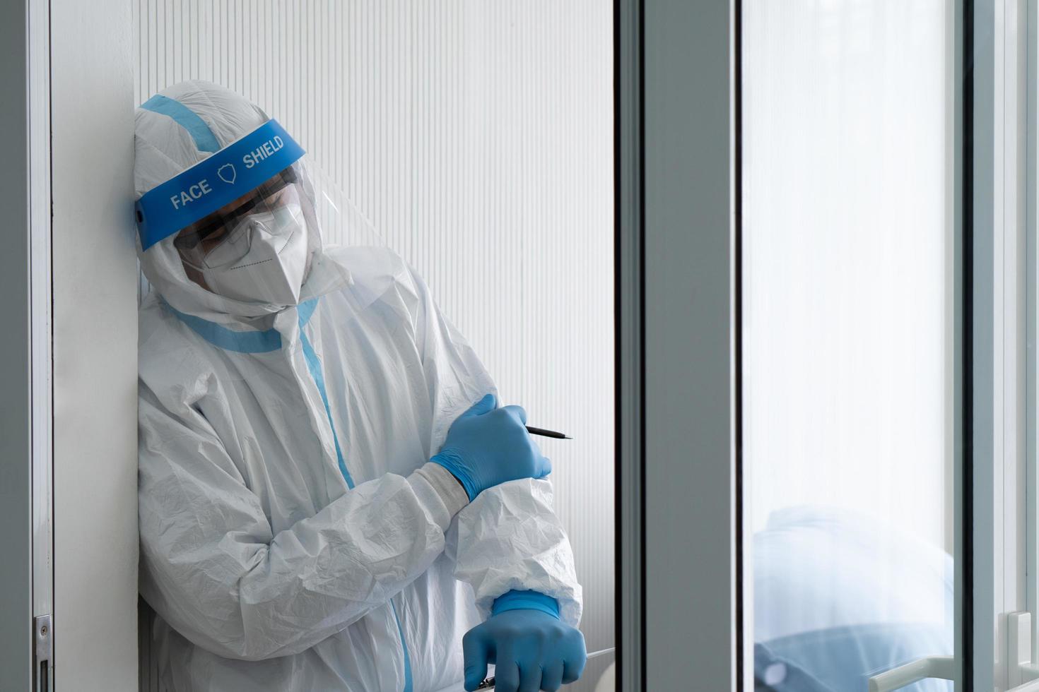 Doctor in personal protective equipment or ppe feeling sad after patient with covid-19 or coronavirus infection was dead in the isolation unit during pandemic. medical concept photo