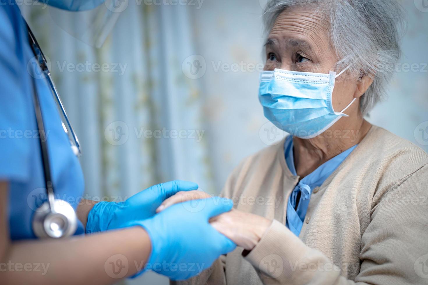 Asian senior or elderly old lady woman patient wearing a face mask new normal in hospital for protect safety infection Covid-19 Coronavirus. photo