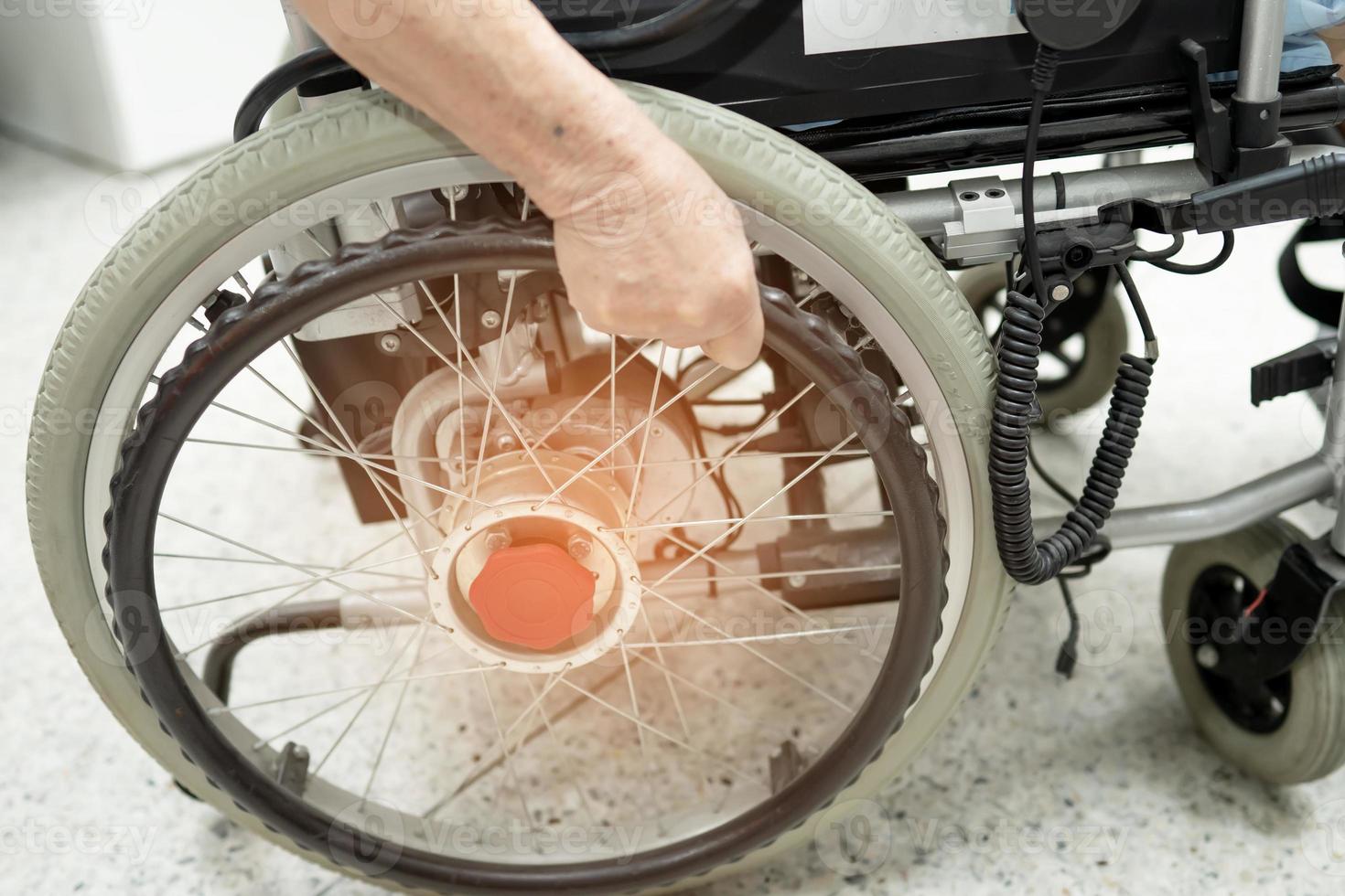 Asian senior or elderly old lady woman patient on electric wheelchair with remote control at nursing hospital ward, healthy strong medical concept photo