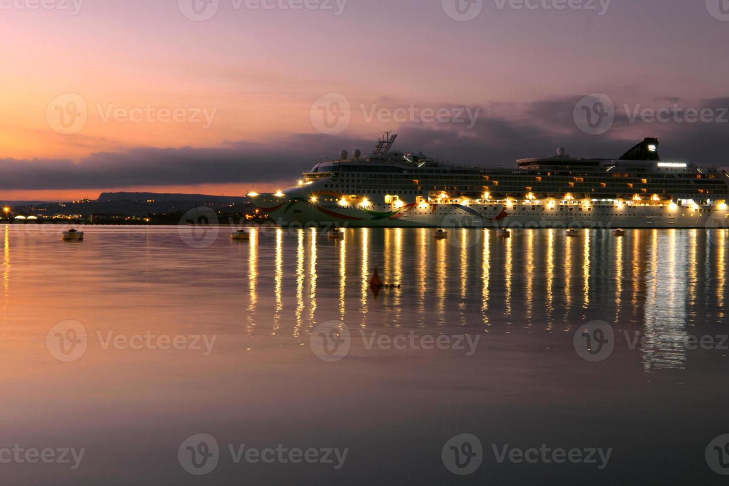 Cruise ship docked at the port at sunset photo