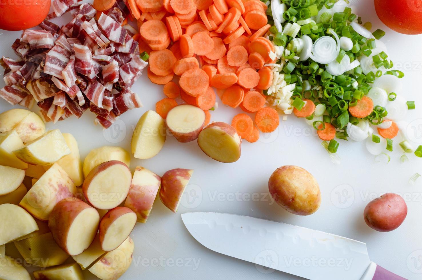Spring vegetables and bacon on the kitchen table.Healthy foods are on the table. Homemade food preparation. photo