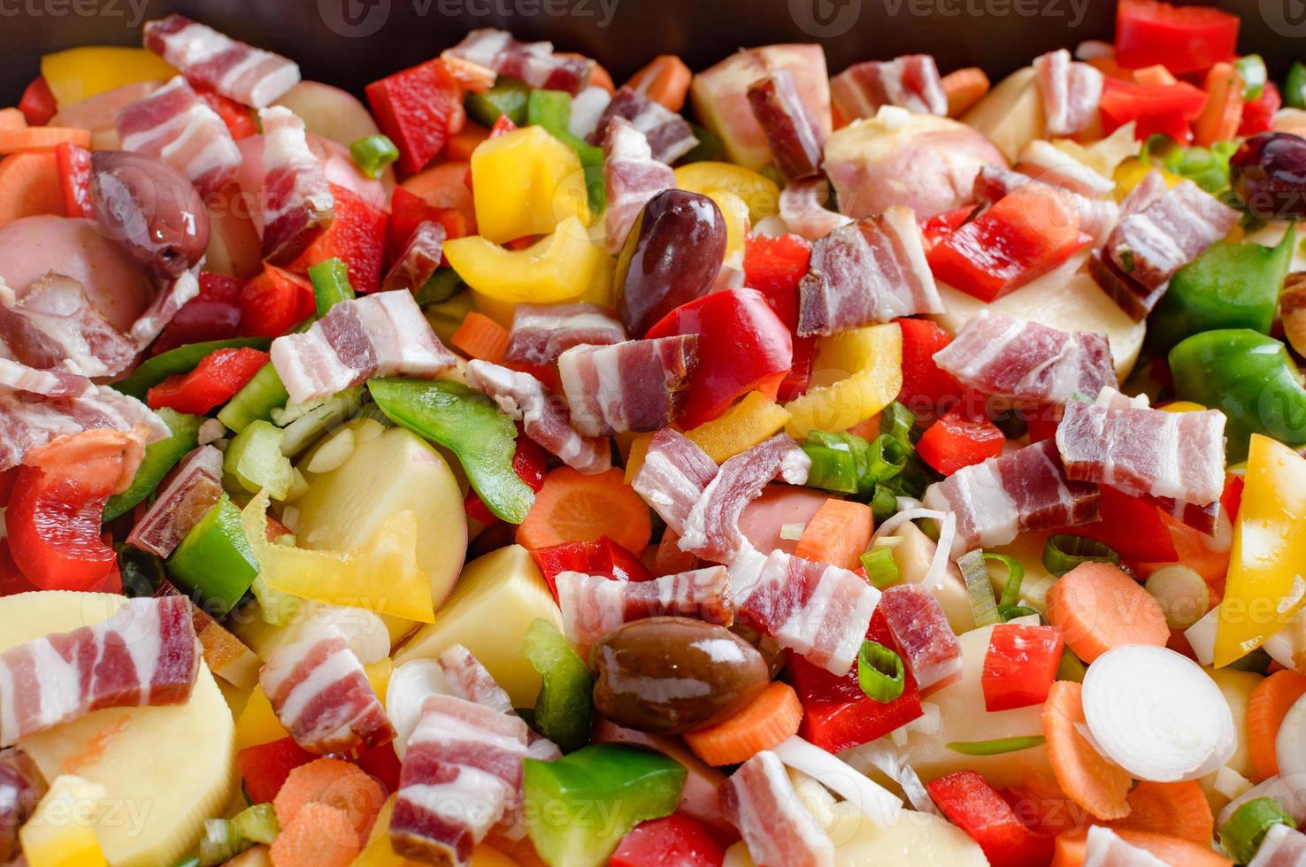 Spring vegetables and bacon on the kitchen table.Healthy foods are on the table. Homemade food preparation. photo