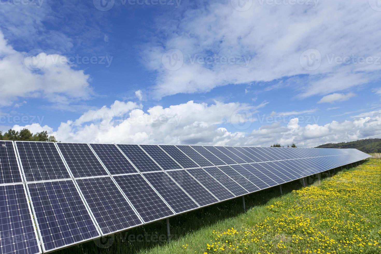 Solar Power Station on the spring flowering Meadow photo