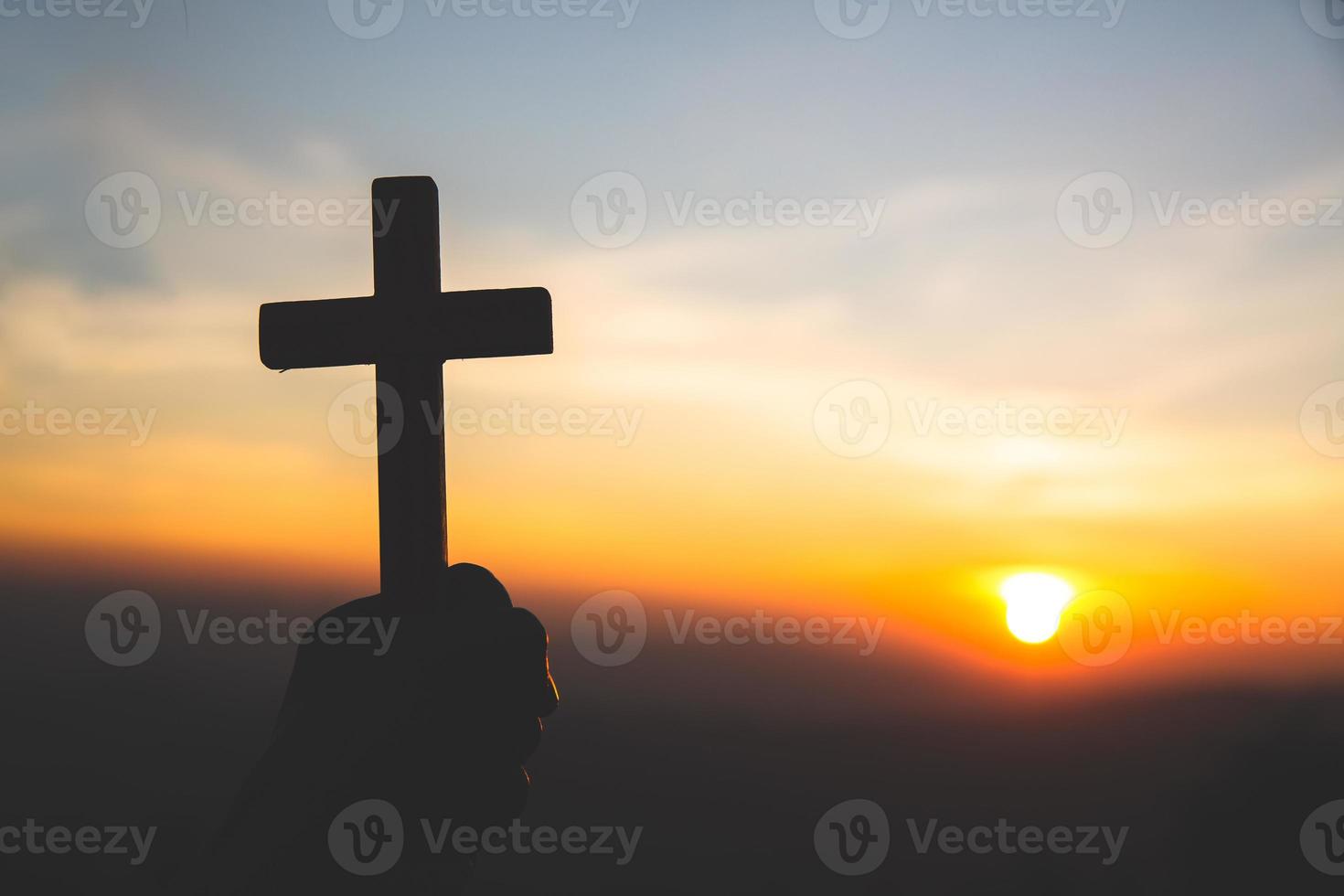 Young praying womans hands with wooden cross and Holy Bible. Religion concept photo