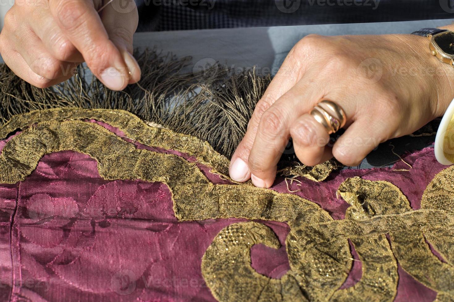 Restoration of tapestries with gold thread, in a workshop in Portugal photo