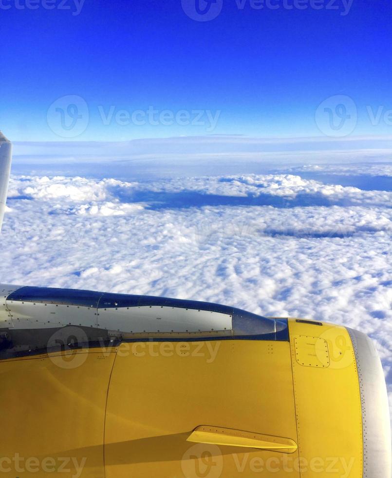 Airplane flying over the clouds photo