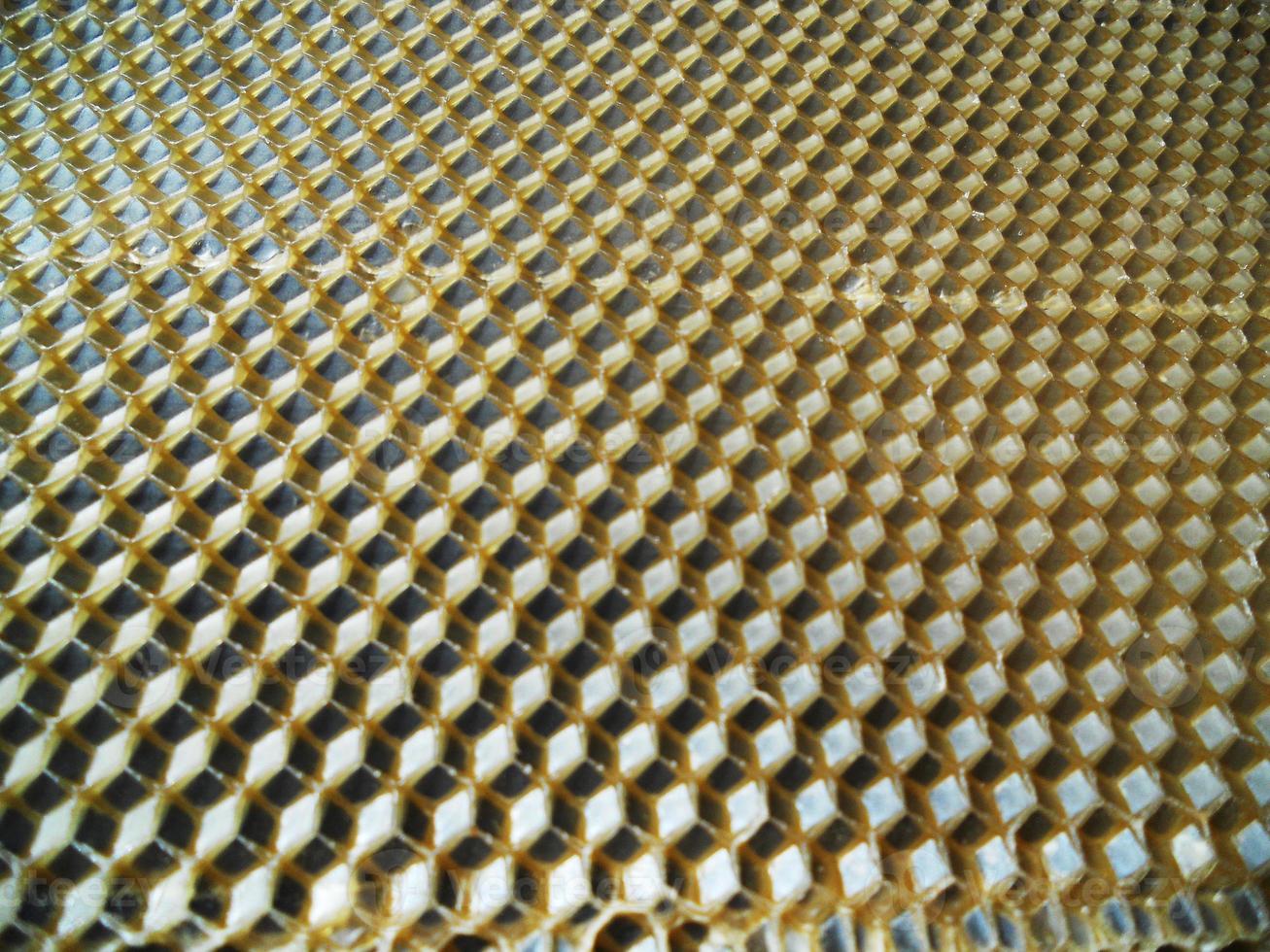 Fondo de textura hexagonal, panal de cera de una colmena de abejas foto