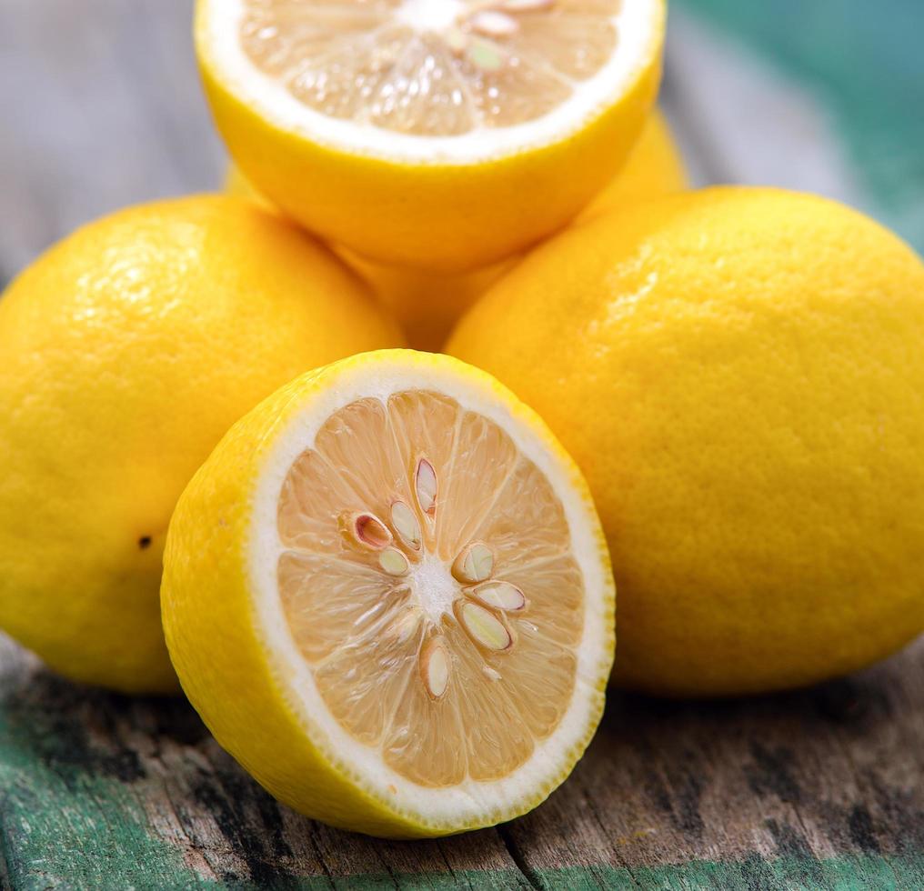 Fresh lemons on wooden table photo