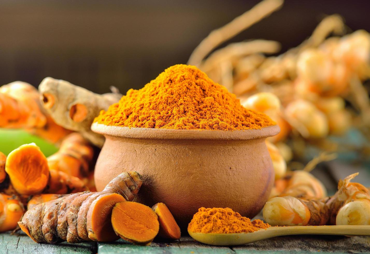 turmeric roots on wooden table photo