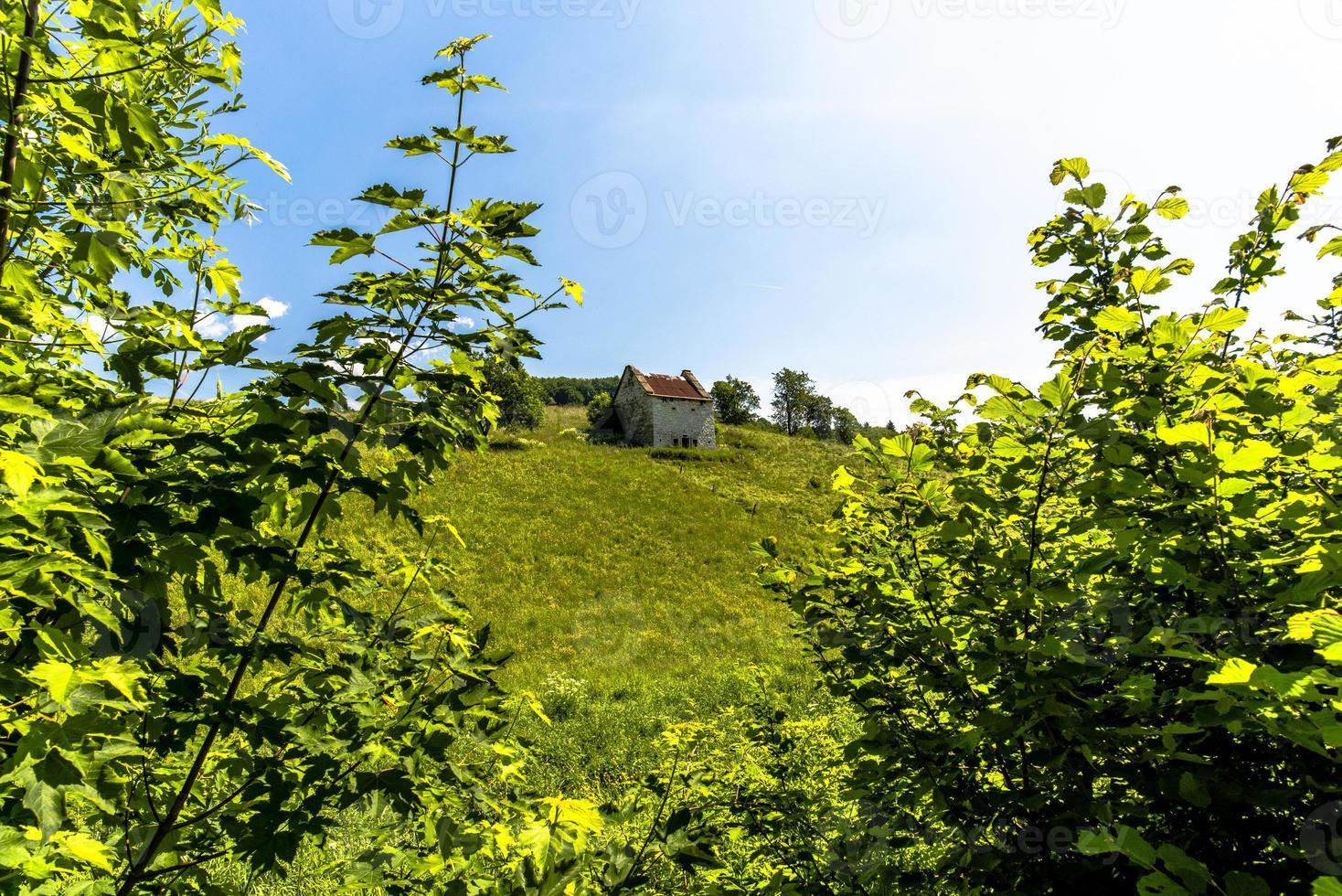 Abandoned farmhouse on a hill photo