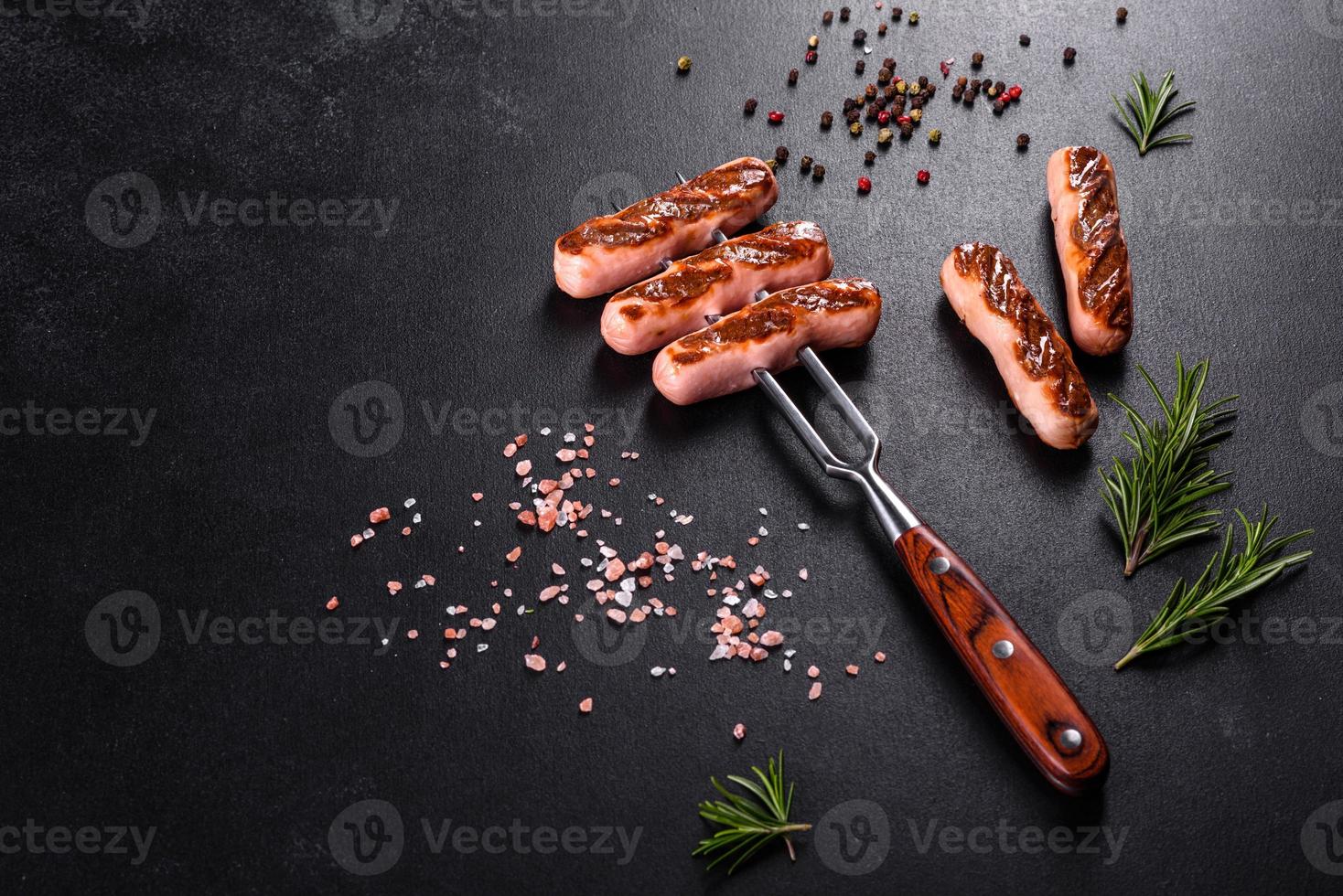 Tasty, fresh sausages grilled with vegetables spices and herbs photo