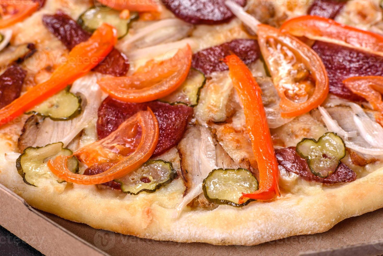 Fresh delicious pizza made in a hearth oven with sausage, pepper and tomatoes photo