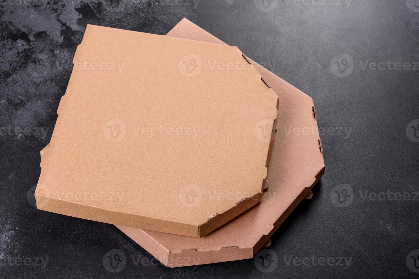 Cardboard brown box of square shape for transportation and delivery of pizza photo