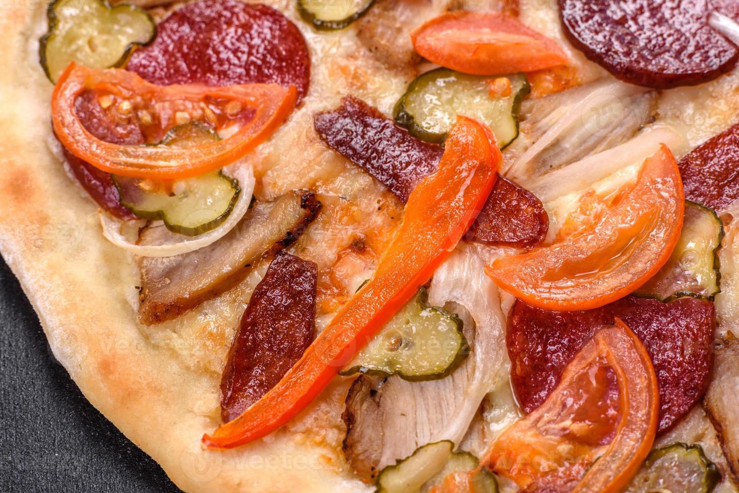 Fresh delicious pizza made in a hearth oven with sausage, pepper and tomatoes photo